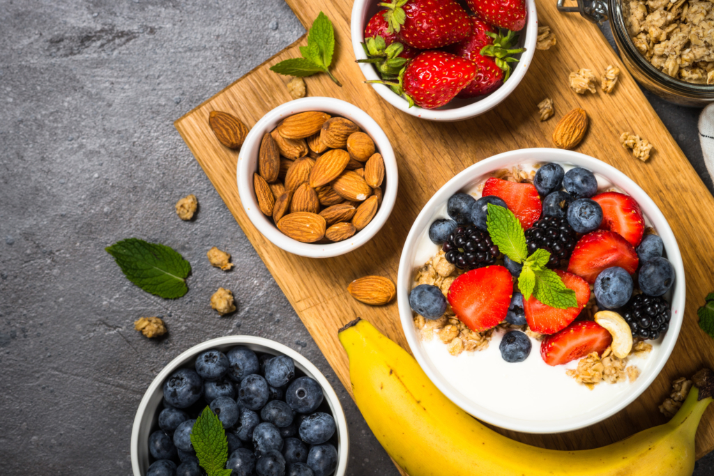 Greek yogurt granola with fresh berries on stone table, top view, copy space. Healthy food, snack or breakfast.