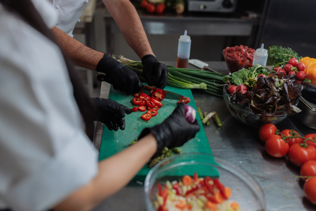 Chef cutting a red pepper