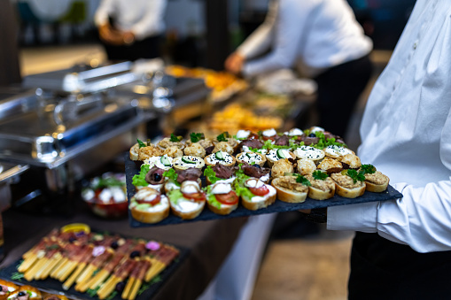 Caterer carries appetizers at an event.